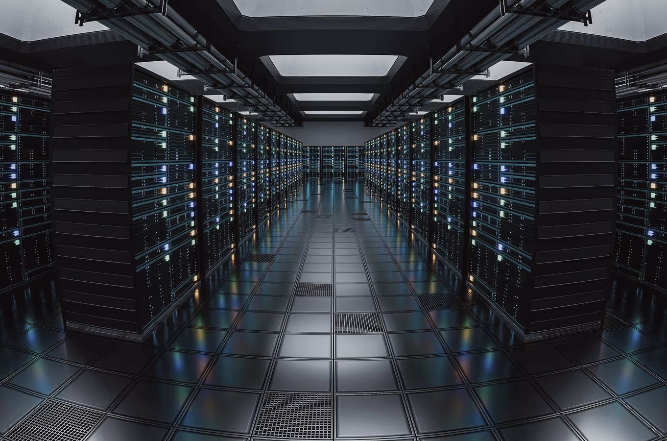 Row of illuminated server racks in a dark, modern data center corridor.